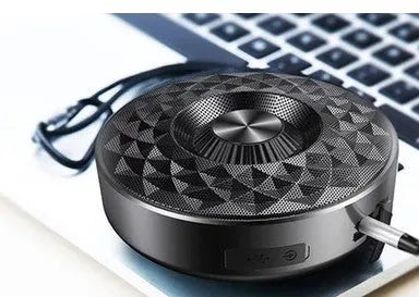 Compact black Bluetooth speaker with silicone cover showing control buttons.