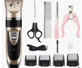 Golden professional cordless pet grooming clipper kit with ceramic titanium blade, four guide combs, nail clippers, and file on a table