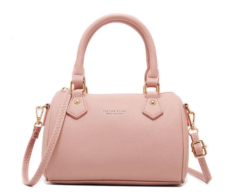 Ladies pillow crossbody bag in PU with zip closure and letter detail, shown in available colours.