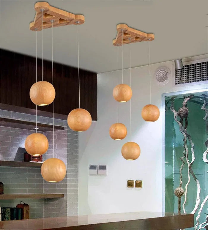 Nordic-style solid wood ball chandelier with adjustable cord and wood disc shade.