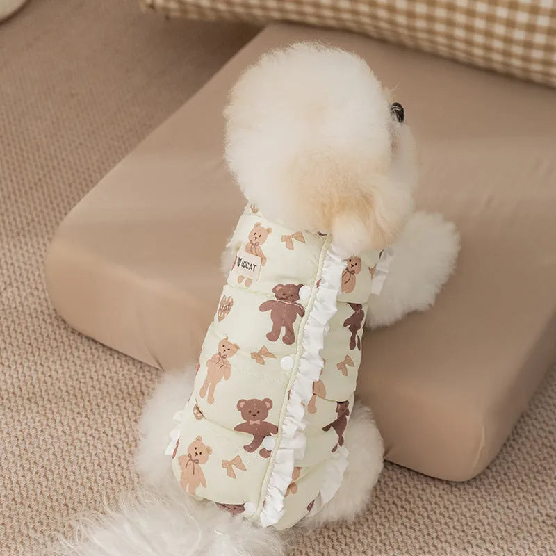 Cream fleece pet jumpsuit with bear print and white ruffles, four-legged design on small dog