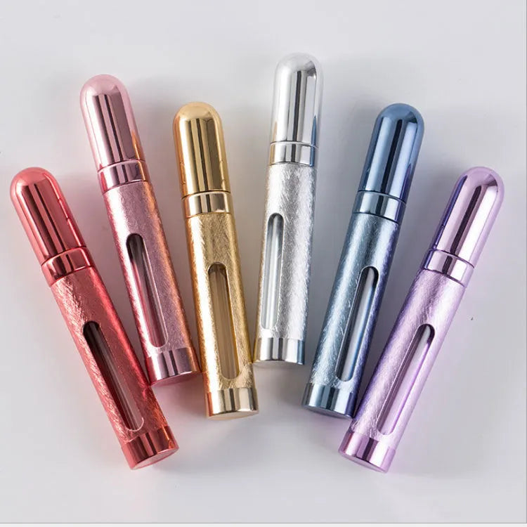 Refillable aluminium travel perfume atomiser with glass liner in blue, gold, pink, red, silver, or violet.