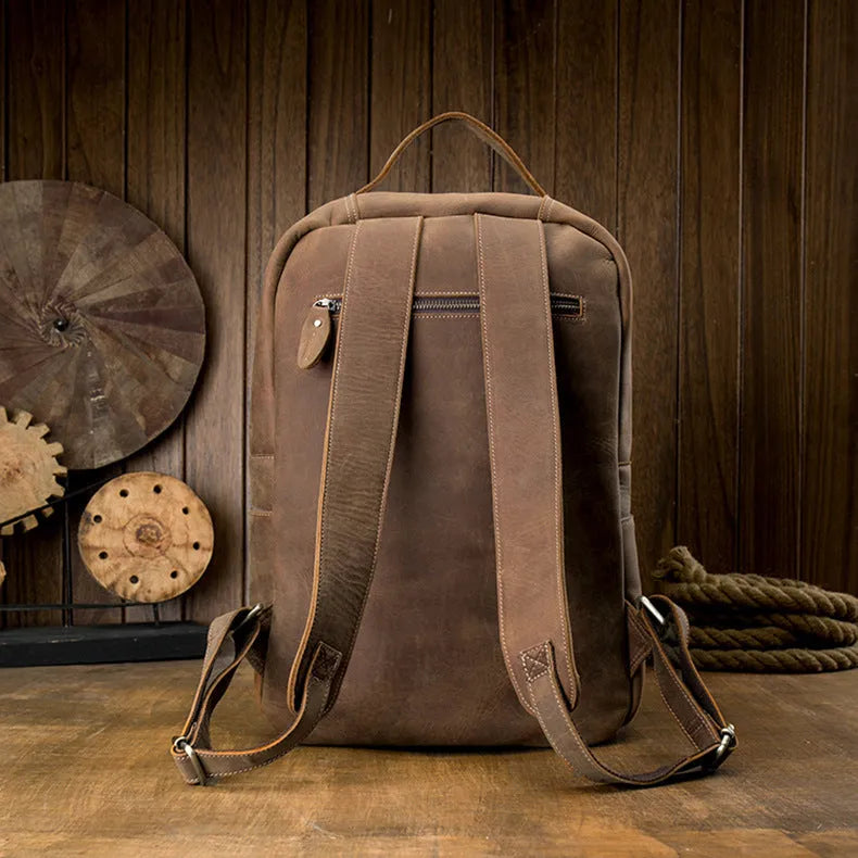 Retro brown leather backpack for men, 20L bucket shape with zipper, laptop pocket and phone pouch.