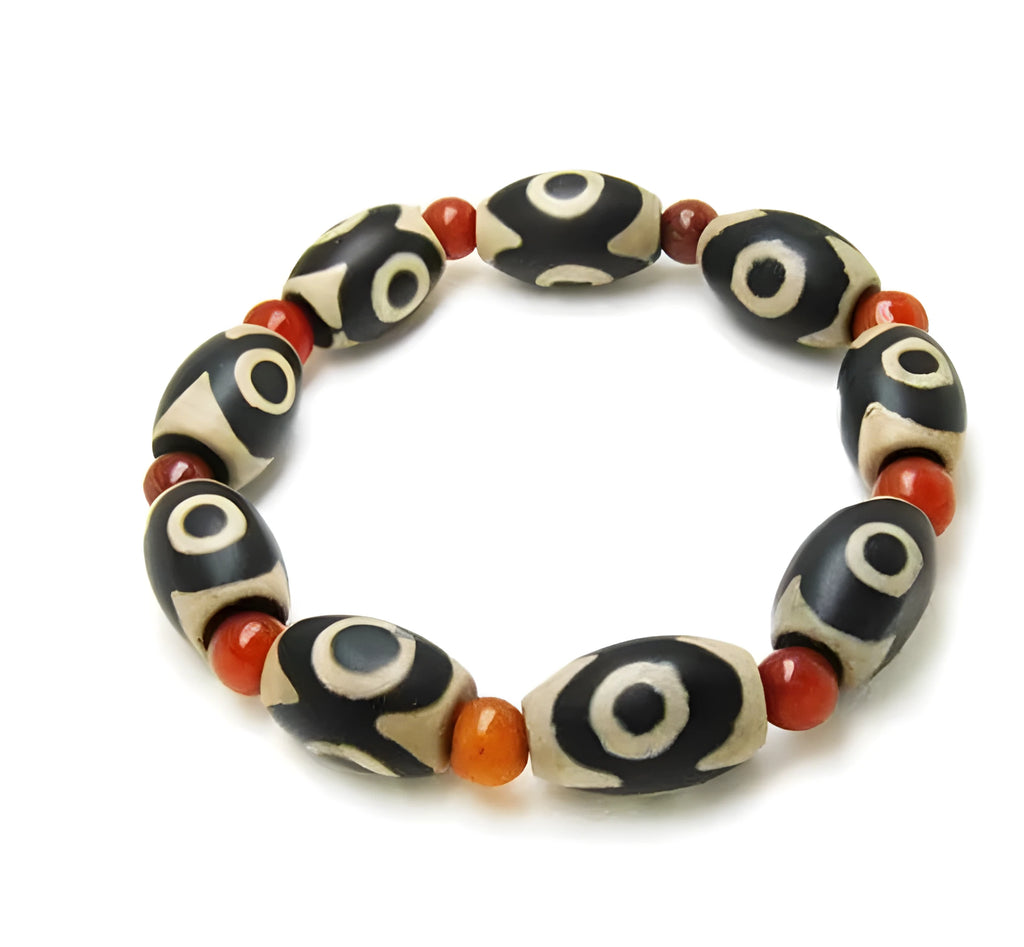 Three-eyed dzi bead bracelet with 10 barrel dzi beads and 6mm red agate beads, 6 inch