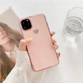 Solid colour TPU back cover case for iPhone on a table, showing blue, claret, pink, and green options.
