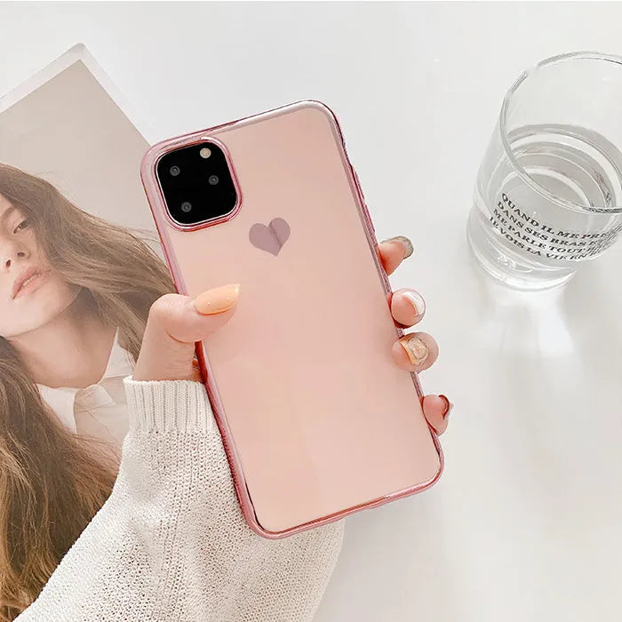 Solid colour TPU back cover case for iPhone on a table, showing blue, claret, pink, and green options.