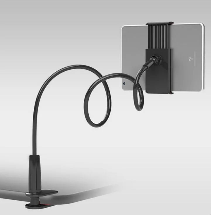 Black aluminium alloy bedside phone handset with a long arm and wide clamp, holding a mobile phone above a bed.
