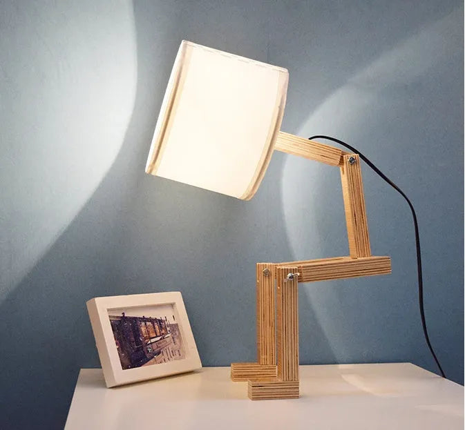 Creative humanoid wooden table lamp with white fabric shade measuring 22x44x16cm