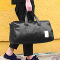 Black waterproof sports fitness bag with separate shoe compartment and diagonal shoulder strap.