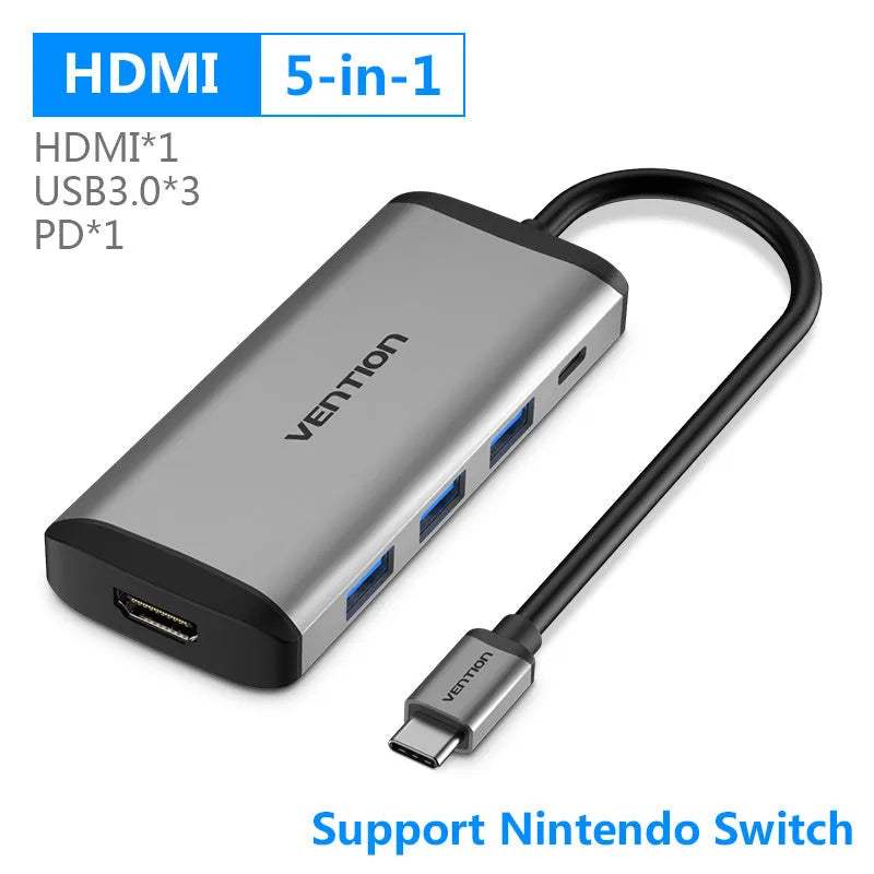 Deep grey CNDHB USB-C hub showing HDMI, Ethernet, USB ports, and card slots next to a laptop.