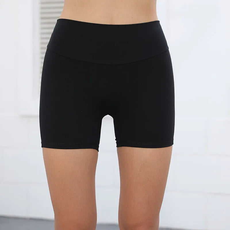 Women's high waist nylon fitness shorts in avocado green with side pockets, laid flat.