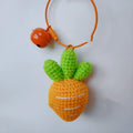Soft wool keychain pendant shaped like a cartoon carrot car on a keyring.