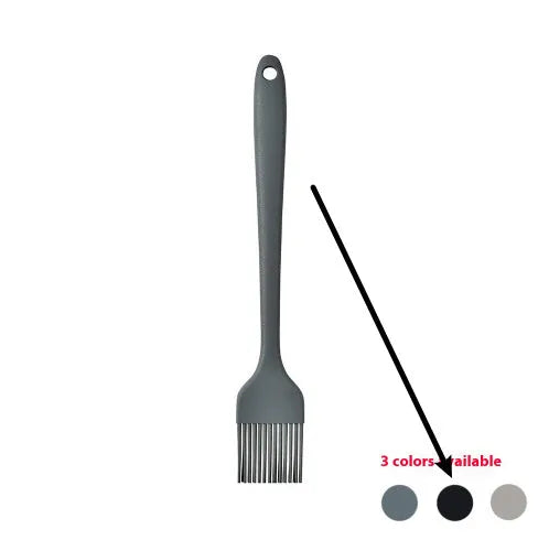 Black silicone kitchen utensil set with 12 tools stored in a rotating plastic storage bucket on a worktop.
