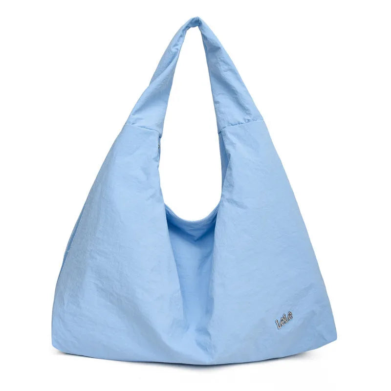 Women's heart-shaped nylon crossbody bag in black, shown from the front.