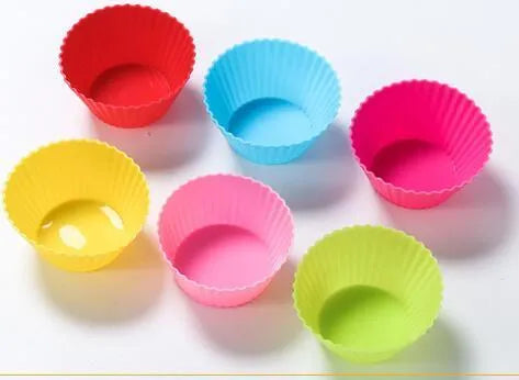 Twelve reusable silicone cupcake liners in six colours, two cups per colour, with a nonstick surface.