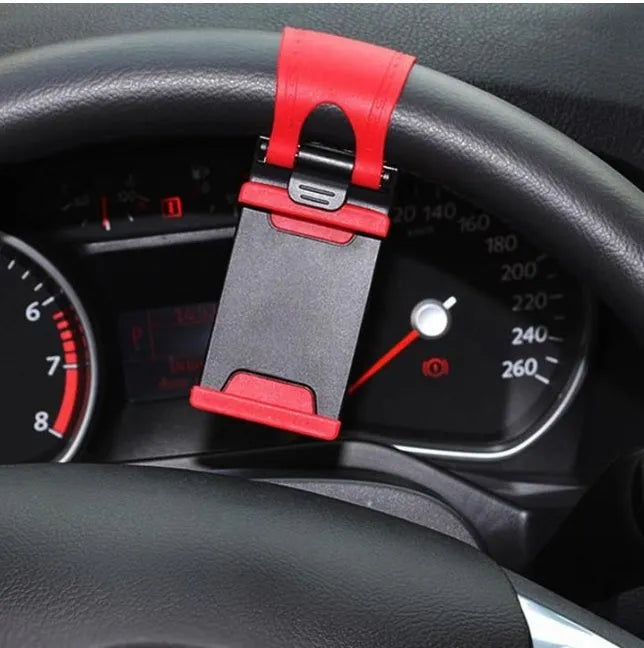 Black steering wheel phone clip holder mounted on car wheel showing phone placement