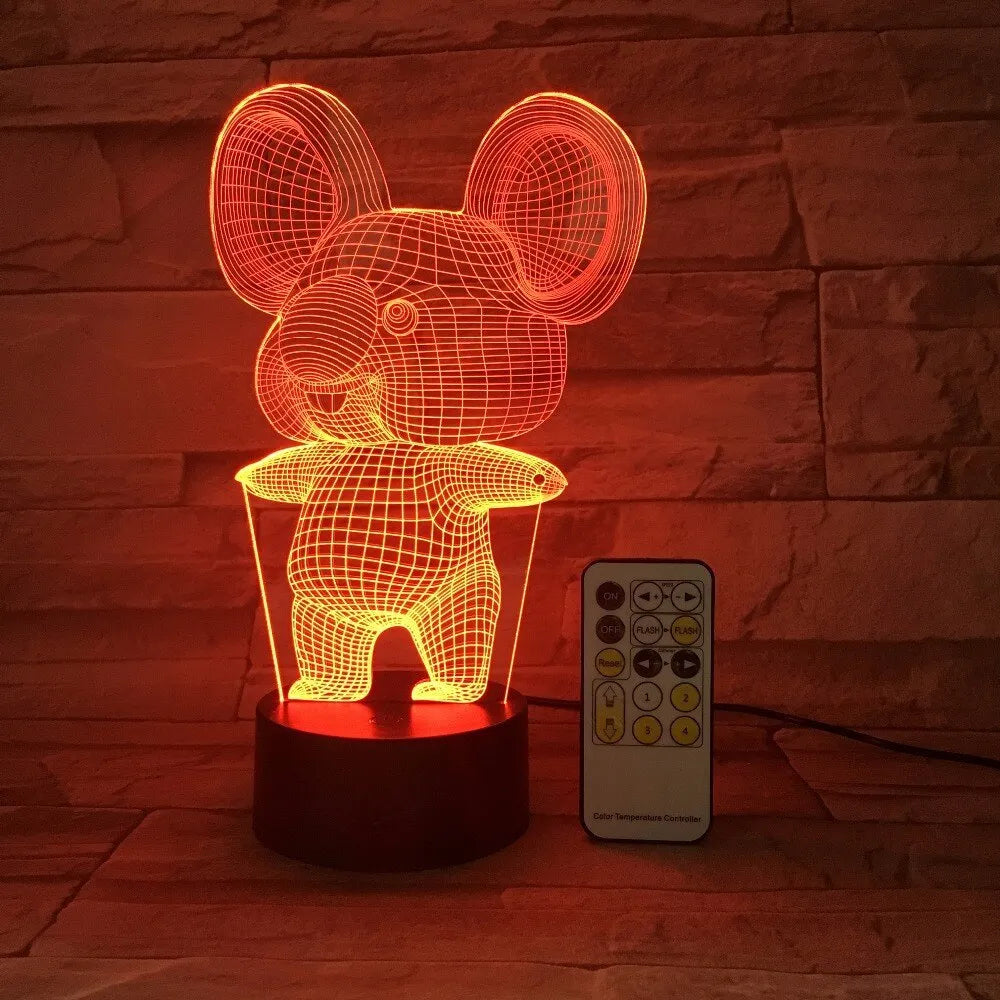 Koala-shaped night light with remote control showing seven colour options on a bedside table