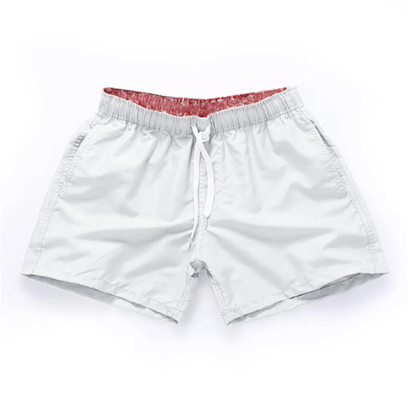 Men's straight-leg polyester beach shorts in black, shown on a model, highlighting the distressed finish and casual fit.
