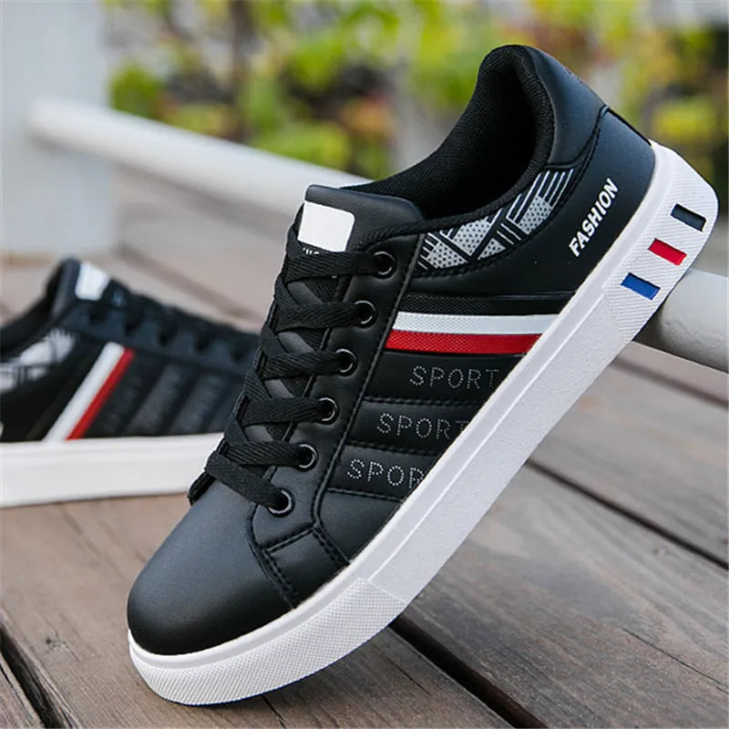 Men's black sports shoes on a white background, showing the classic trainer design and rubber sole.