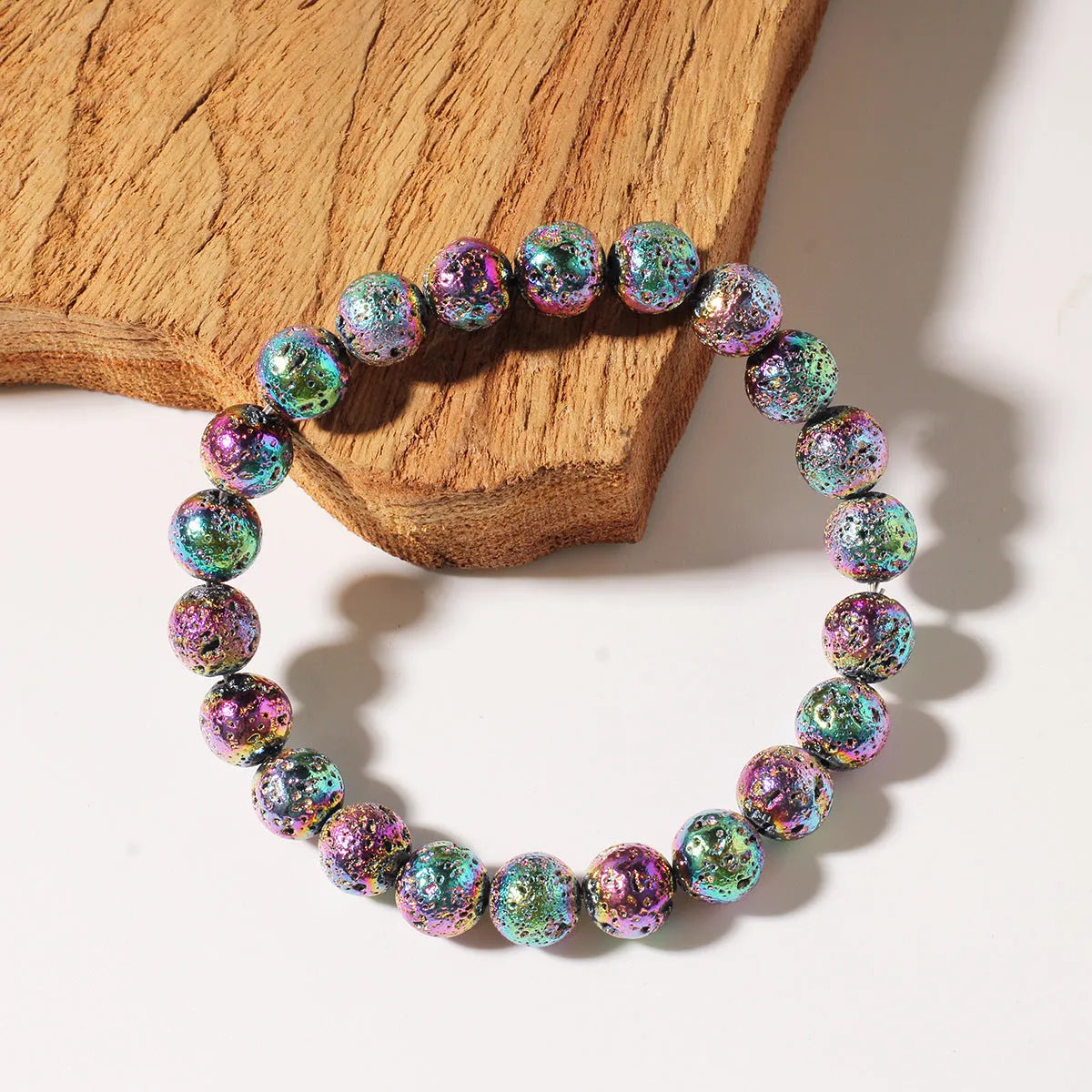 Handmade natural volcanic stone bracelet in seven colours with adjustable cord on white background