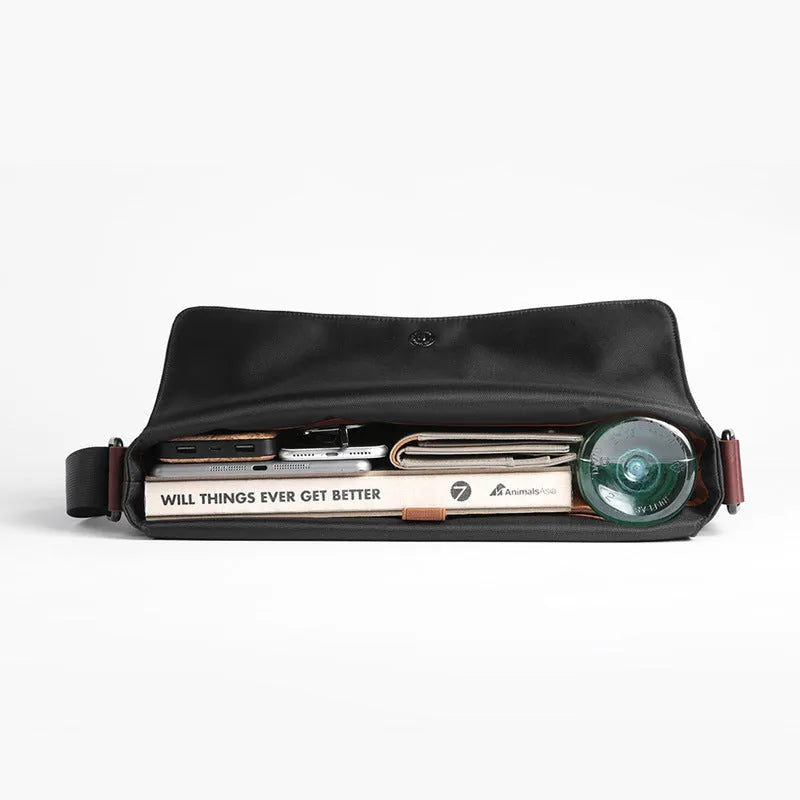 Men's black waterproof tote bag with cross-section square shape, matte finish, and soft handle, designed for 13-inch laptop and business travel