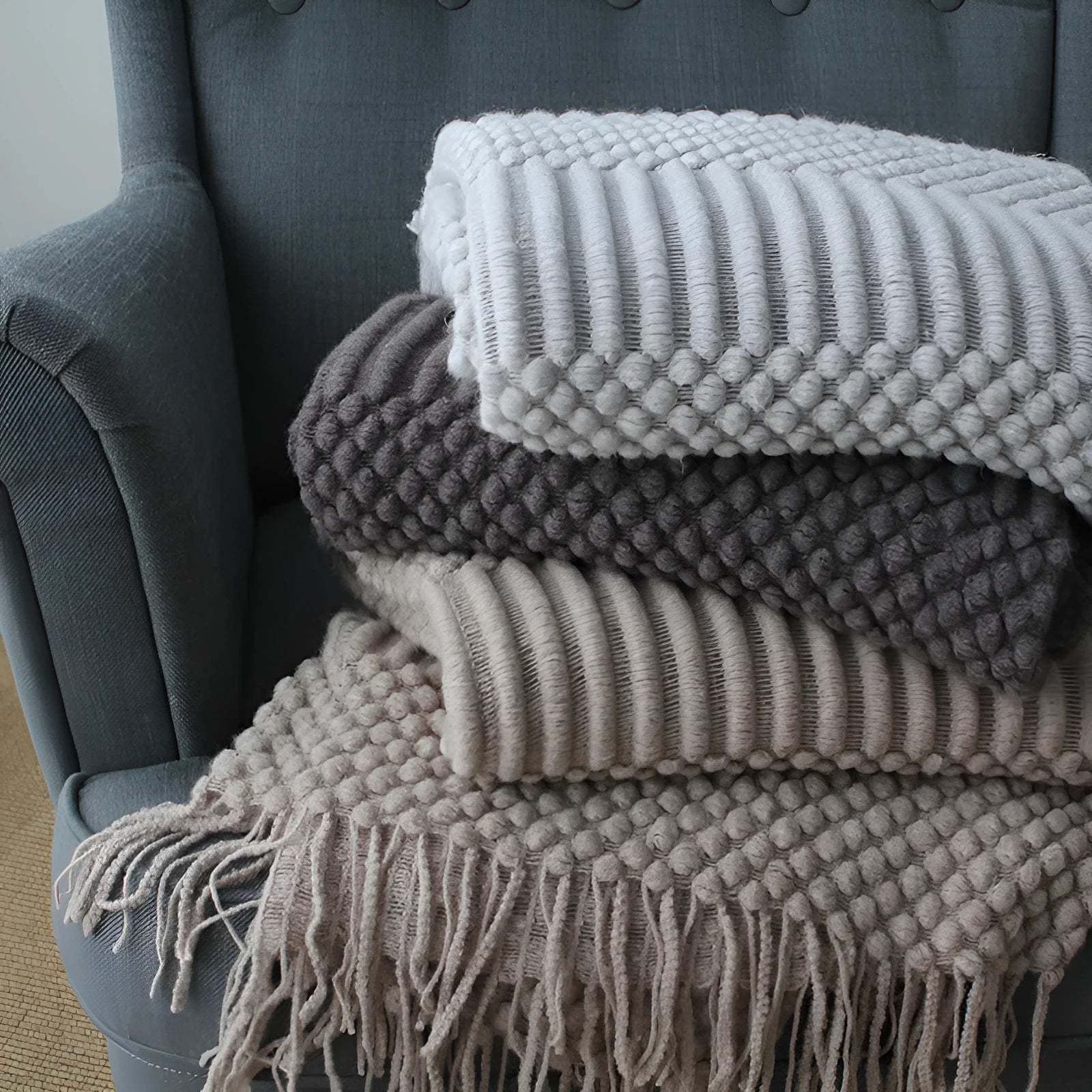 Small light grey polyester nap blanket laid flat showing its 127x170cm size.