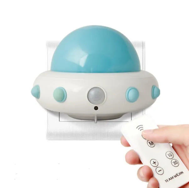 Remote control UFO-shaped bedside night light in blue, pink, or white with cartoon modern design