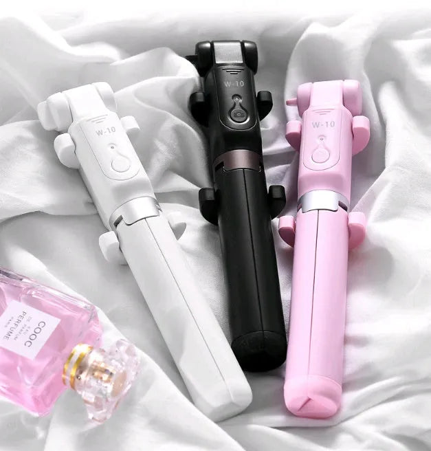 Black Bluetooth selfie stick with extended tripod legs holding a smartphone