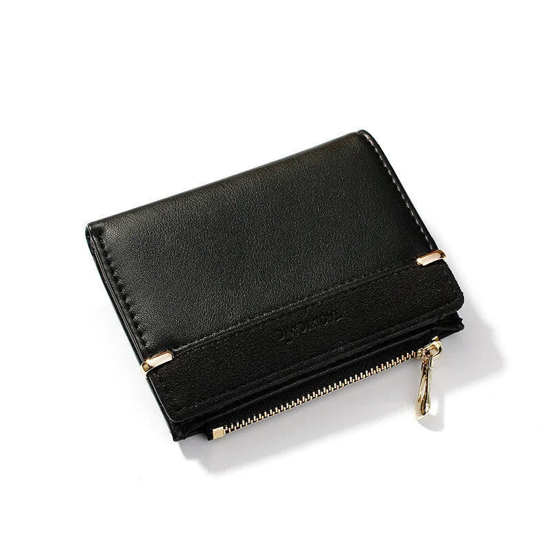 Black ladies short zipper wallet open to show multiple card slots, bill compartment, and change slot.