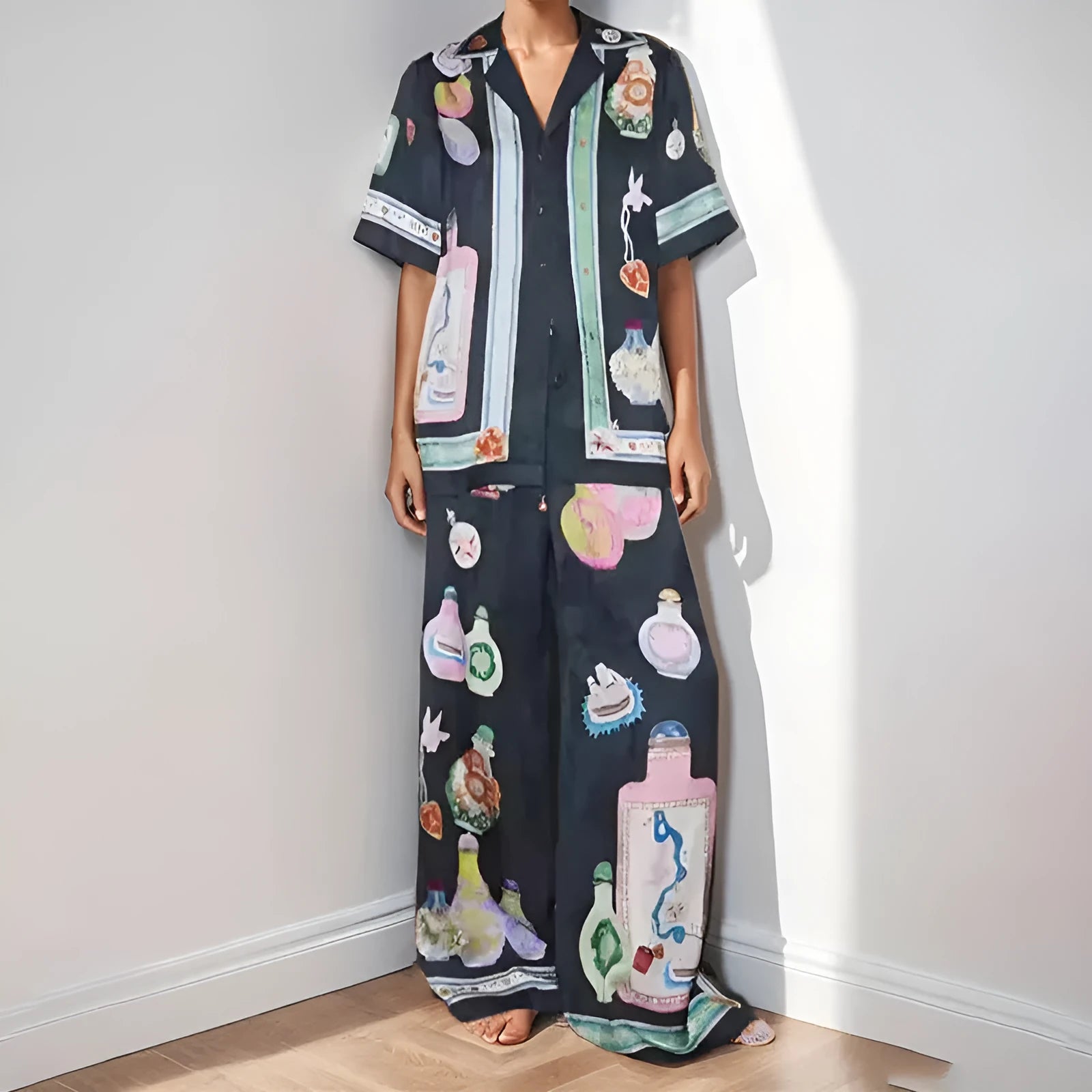 Black women's casual set with cartoon print, featuring a cardigan and trousers.