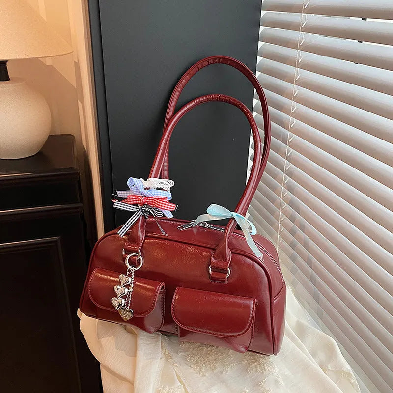 Brown retro pillow-shaped women's handbag with a flap closure and double shoulder straps.