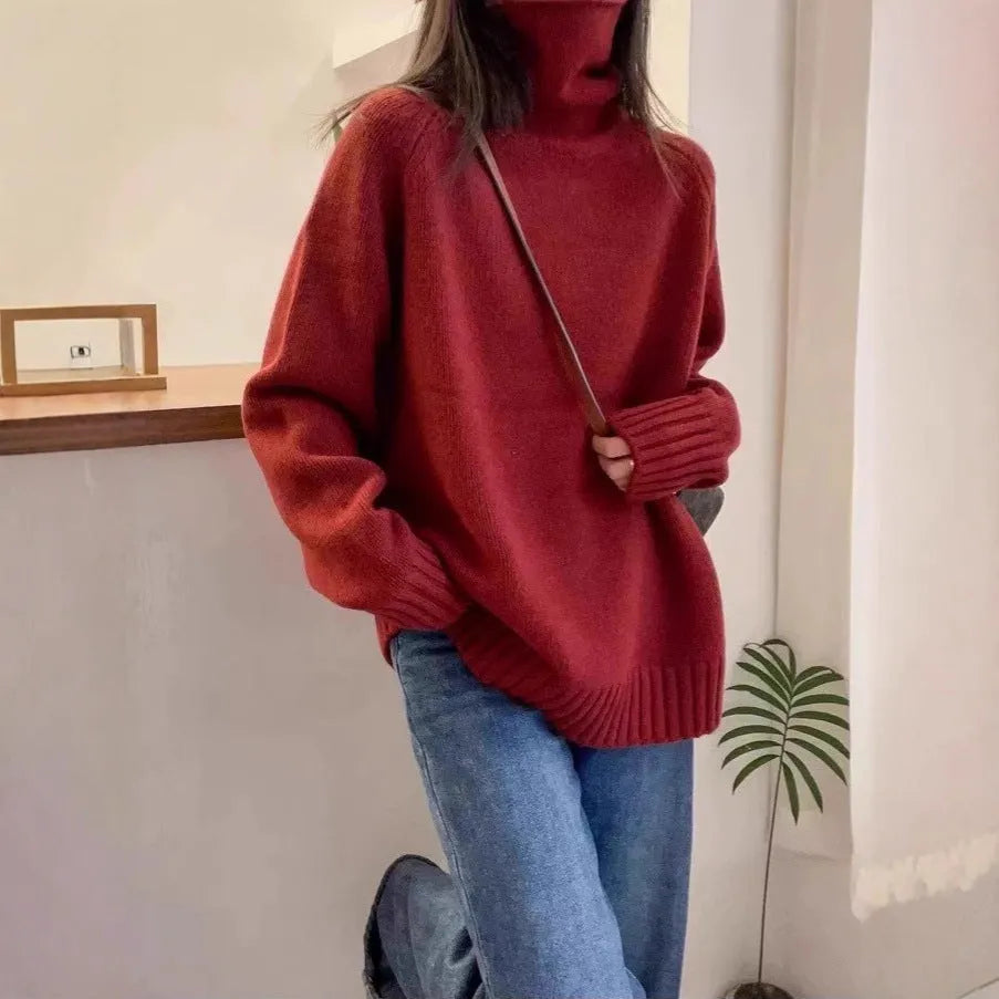 Women's thick grey turtleneck sweater with a textured curling pile collar, loose casual fit.