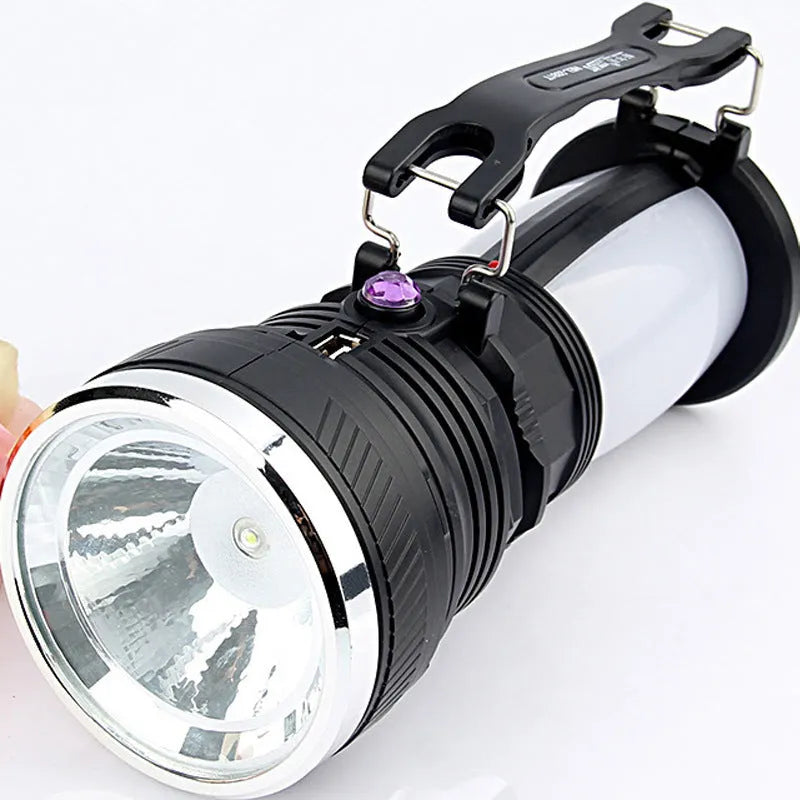 Black solar and USB rechargeable LED flashlight with a press switch.