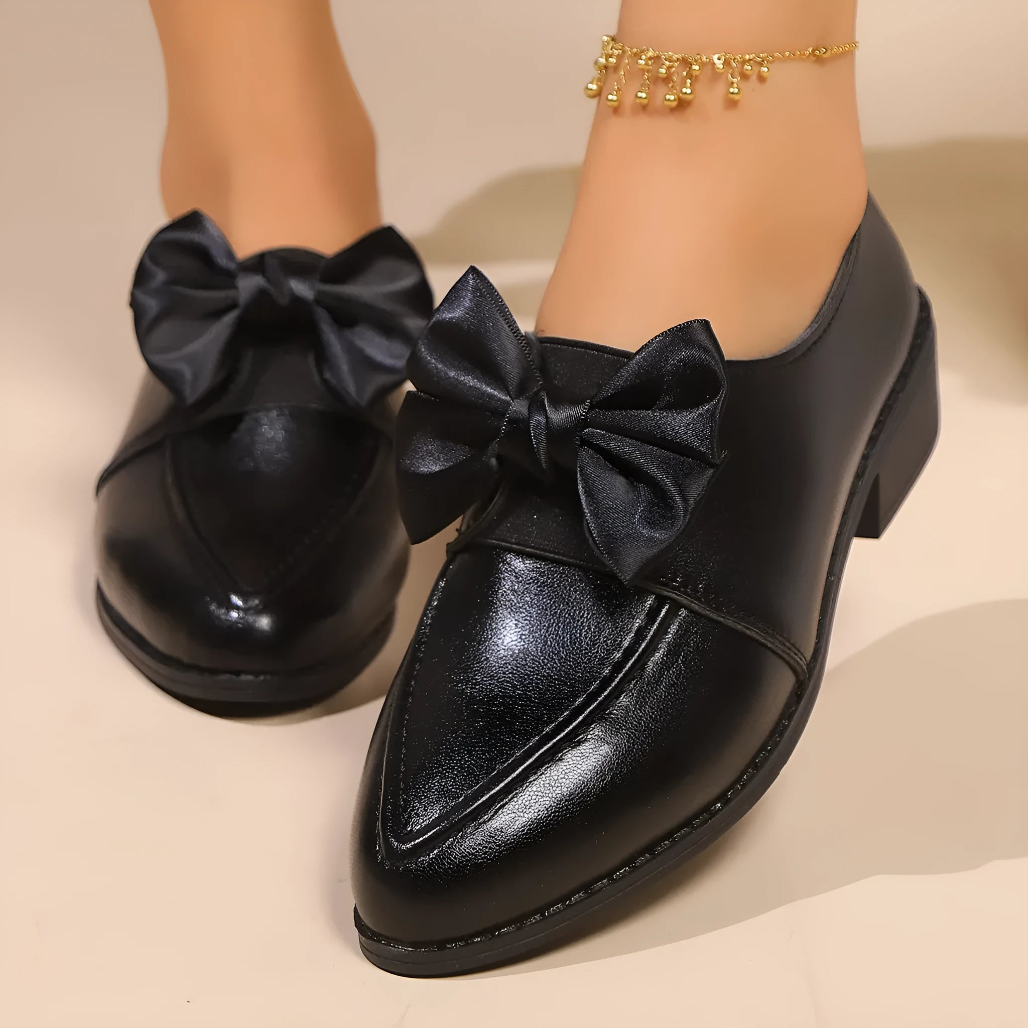 Women's simple leather shoes with a choice of large buckle bow or small bowknot decoration, pointed toe, and rubber sole.