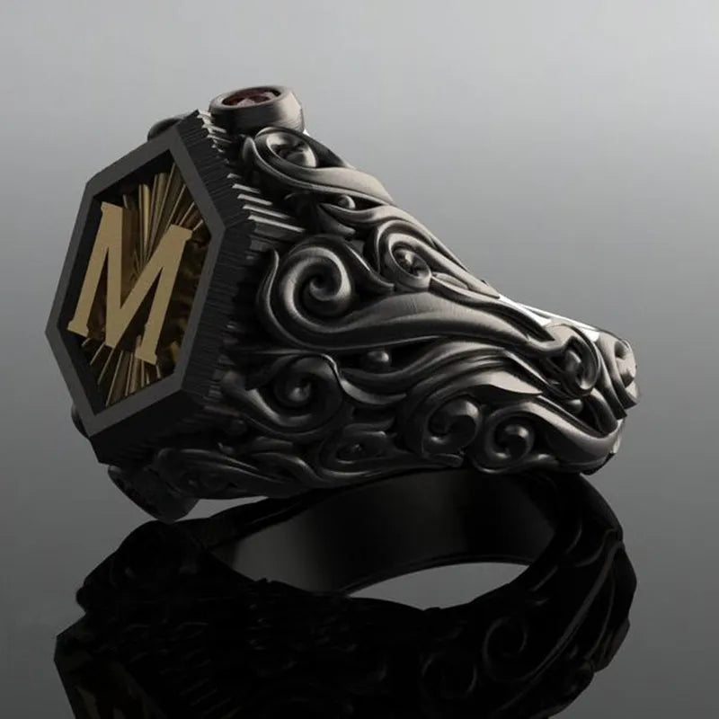 Black alloy decorative ring with carved leaf design on white background