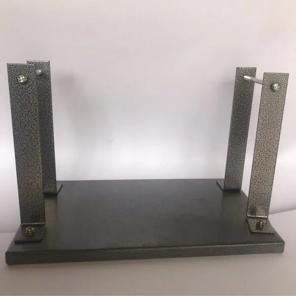 Black iron flip chip bracket for mounting an electric planer inverted on a workbench.