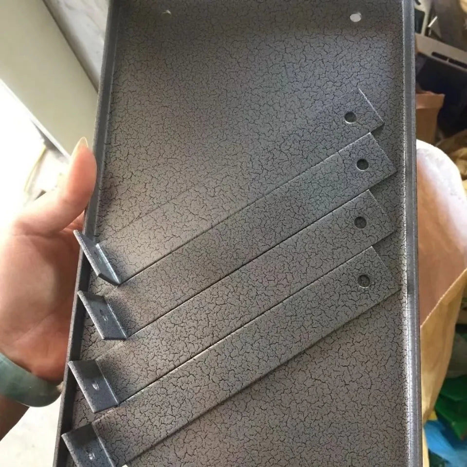 Black iron flip chip bracket for mounting an electric planer inverted on a workbench.