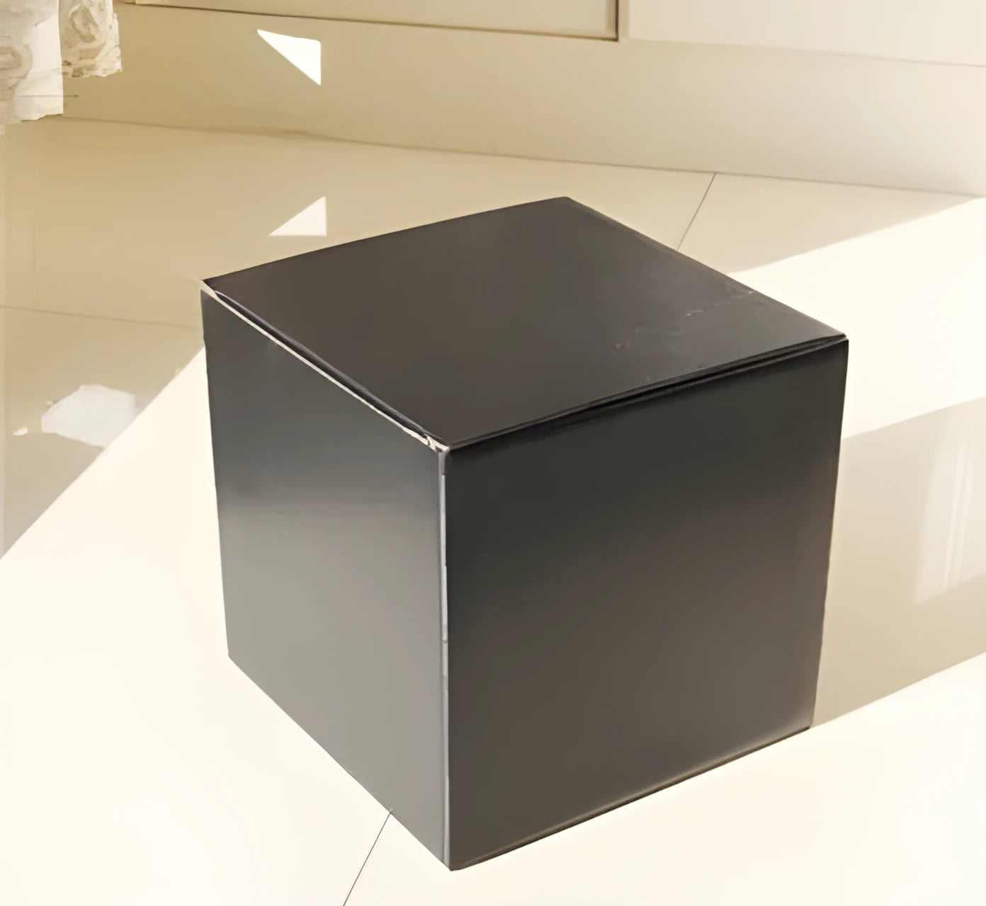 Square corrugated cardboard packaging box in black, brown, grey, and white colour options on a white background.