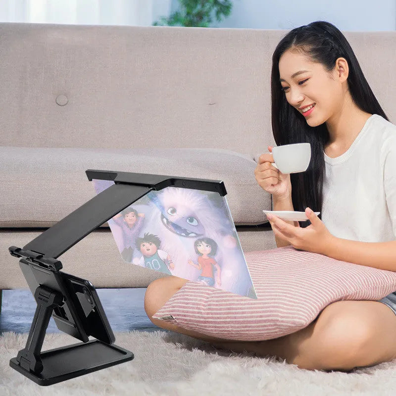 Black L20 smartphone screen magnifier with acrylic lens and separate plastic mounting bracket on a table.