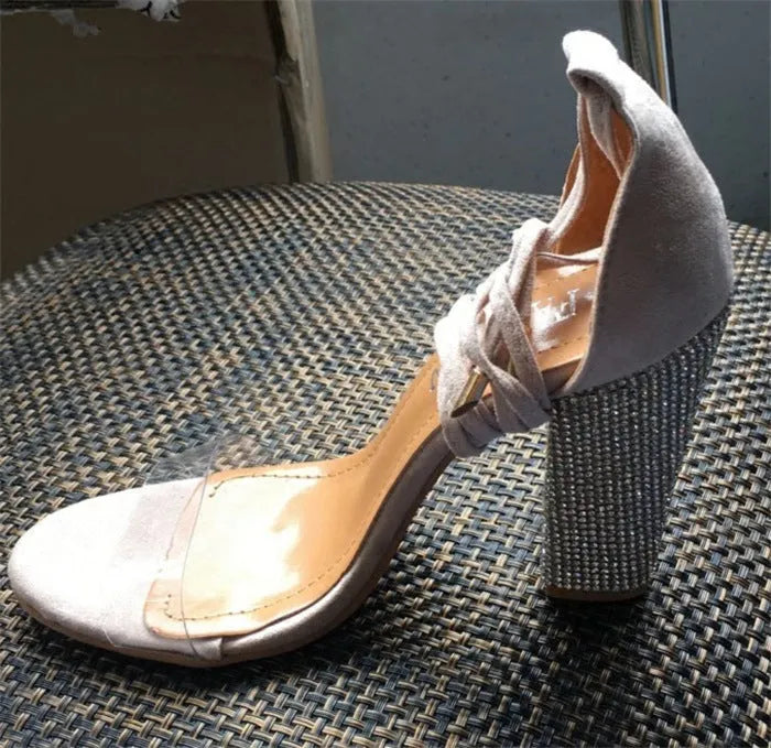 Black and gold pointed toe plastic high heels for women.