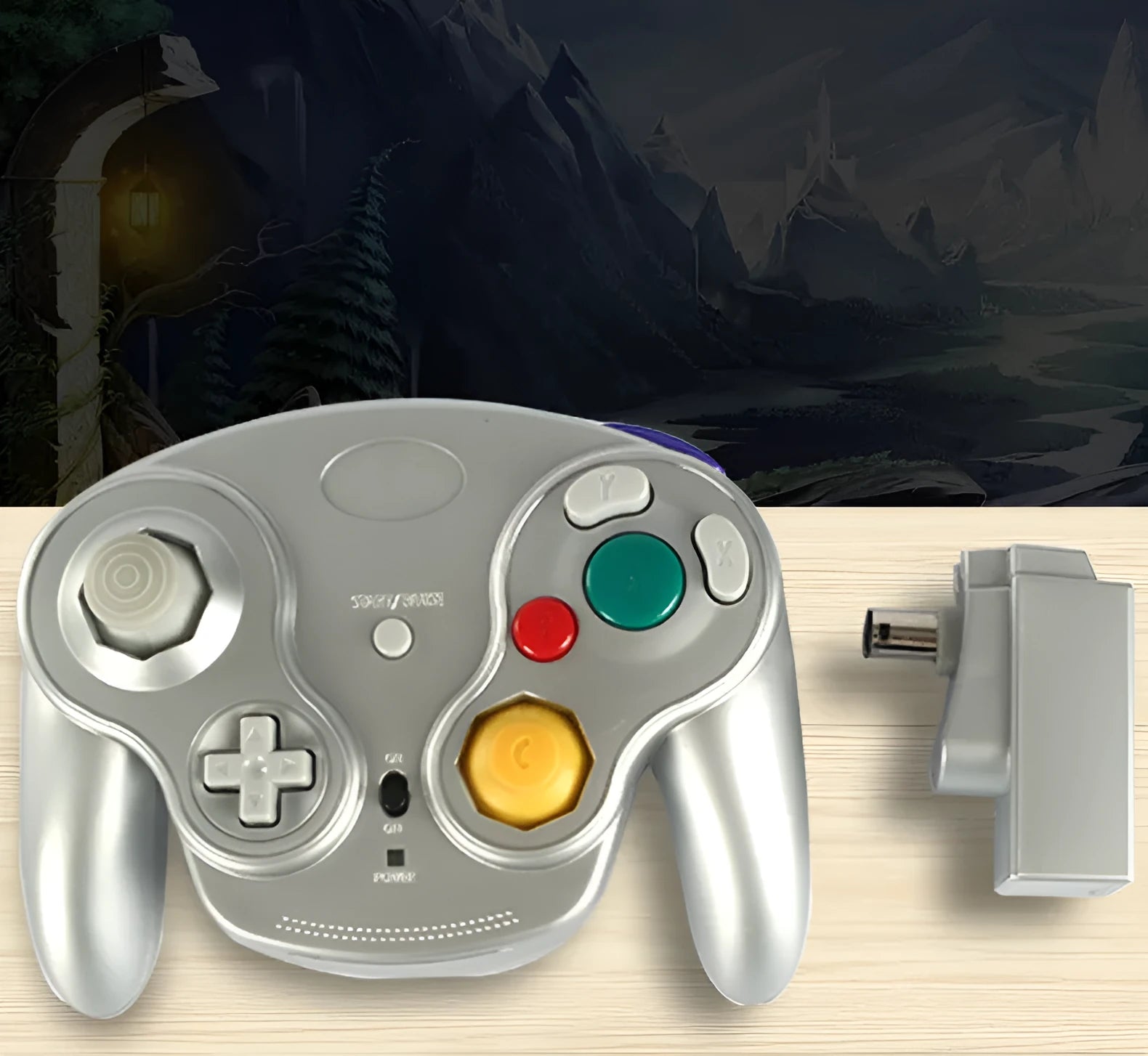 NGC wireless game controller in multiple colours on a grey background, showing its compact size and button layout.