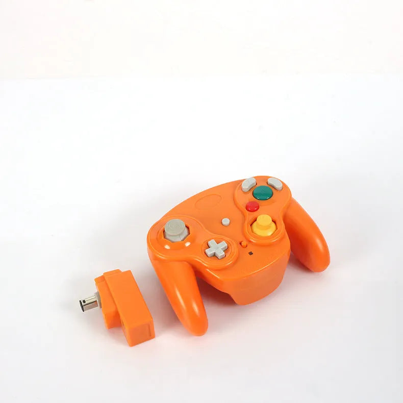 NGC wireless game controller in multiple colours on a grey background, showing its compact size and button layout.