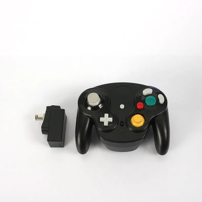 NGC wireless game controller in multiple colours on a grey background, showing its compact size and button layout.