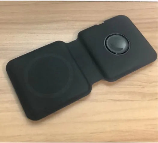 White foldable magnetic wireless charger dock with phone attached, showing angled stand mode.