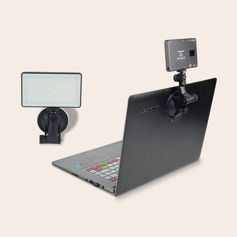 Black aluminium LED video conference light panel mounted on a laptop lid for streaming.