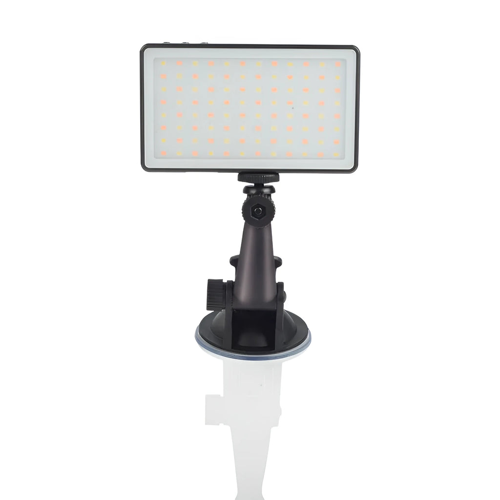 Black aluminium LED conference light with OLED screen, shown next to a laptop.