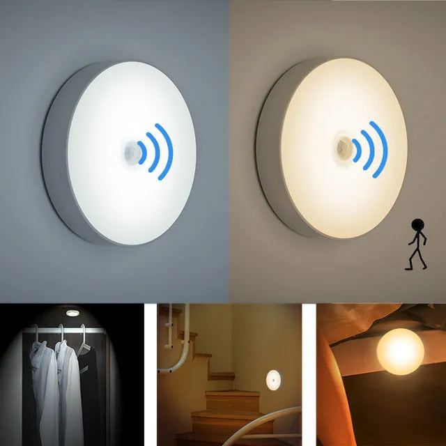 Small white circular motion sensing LED night light with USB charging cable and adhesive tape.