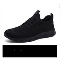 Men's black and white breathable mesh sneakers with round toe and lace-up design for casual sport.