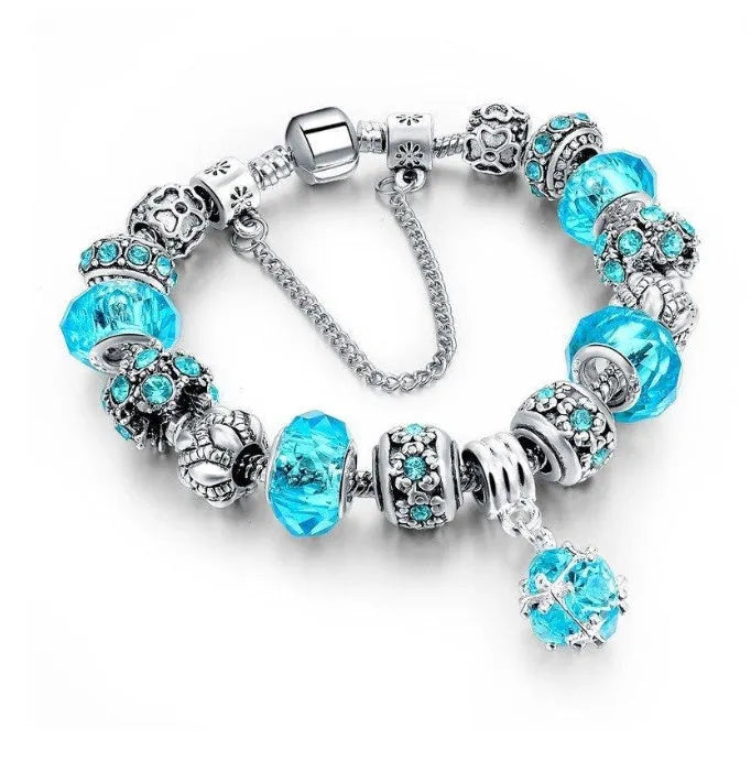 Silver plated alloy bracelet with queen crown beads and pink Murano glass beads for women on white background