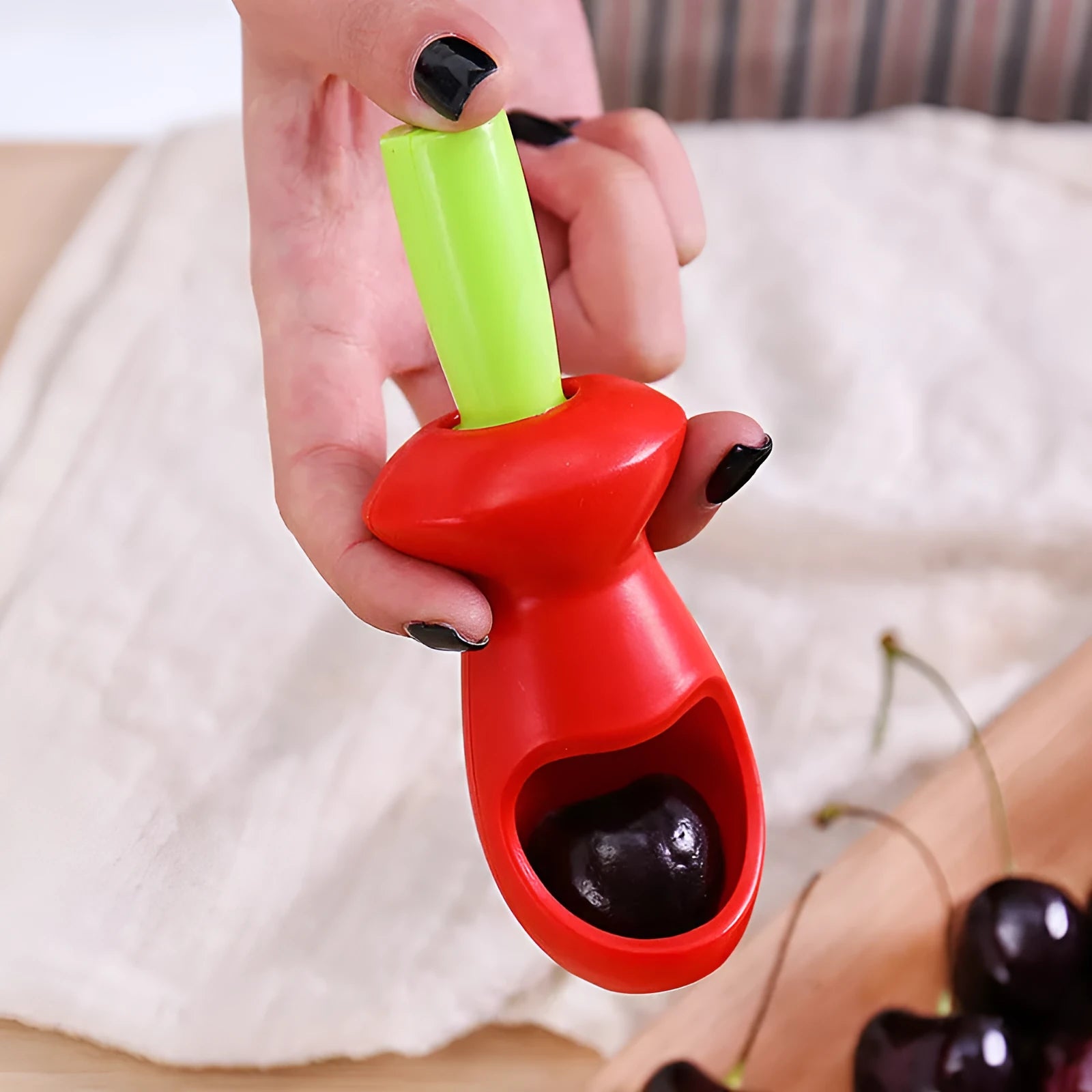 Red PP plastic fruit coring gadget measuring 5 by 13 centimetres on a white background
